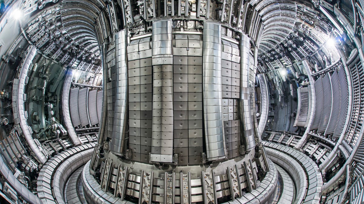 An interior photo shows the Joint European Torus fusion reactor's doughnut-shaped tokamak design