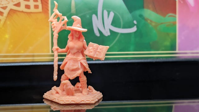 A witch D&D miniature in pink resin