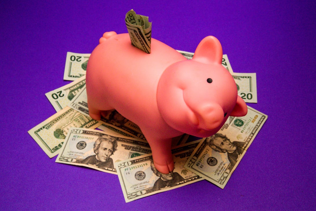 Piggy bank in a pile of money