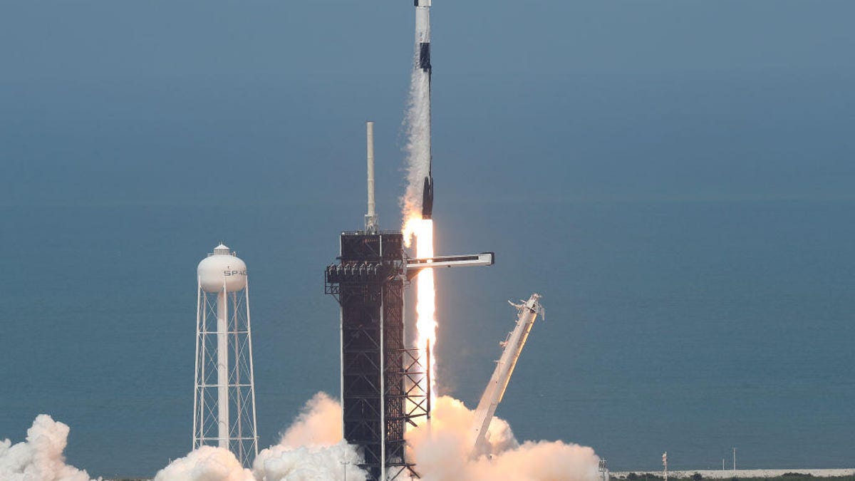 The SpaceX Falcon 9 rocket with the manned Crew Dragon spacecraft attached takes off from launch pad 39A at the Kennedy Space Center.