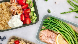 meal prep containers with meals inside