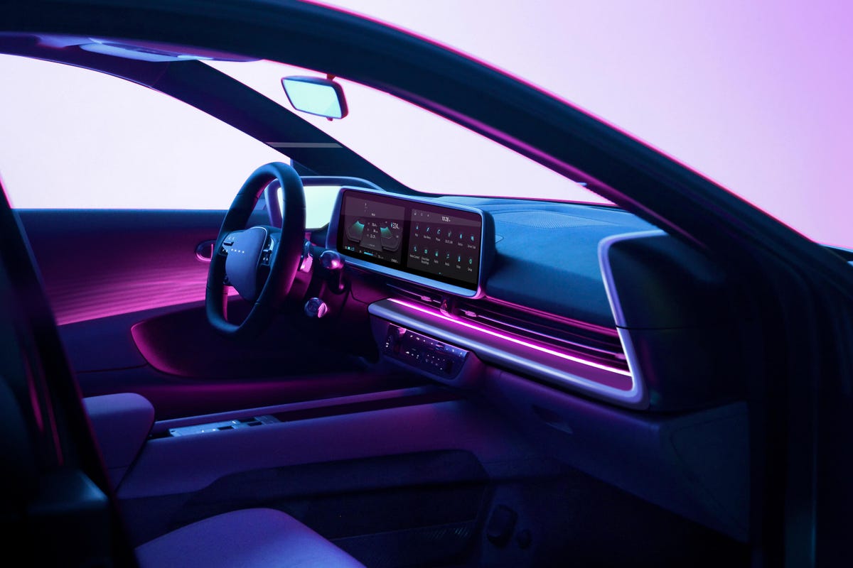 Interior photo of a Hyundai Ioniq 6 electric sedan with pink ambient lighting