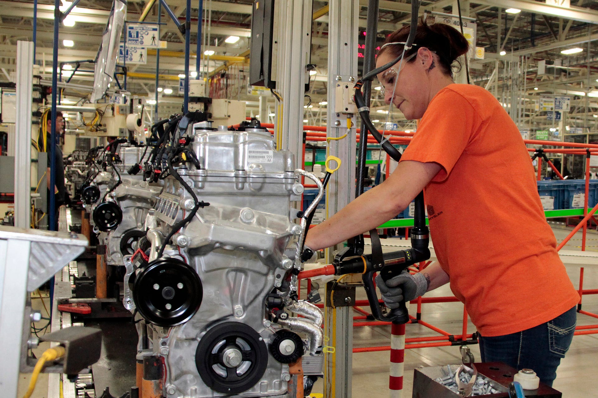 A worker builds a 2.4-liter Tigershark I4 at the Stellantis engine facility in Indiana
