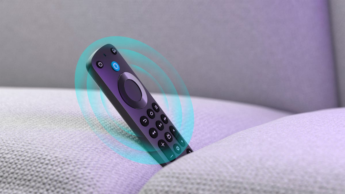 A black remote in between couch cushions with a blue circle around it used to express a beeping sound.