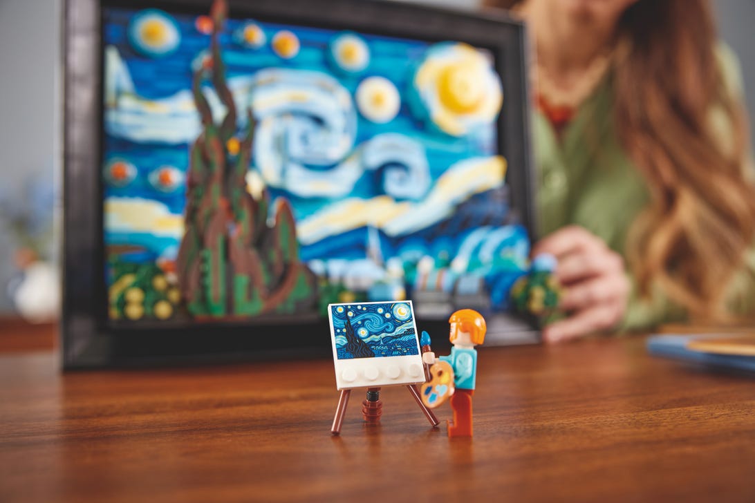 a minifigure of vincent van gogh in front of the lego starry night set