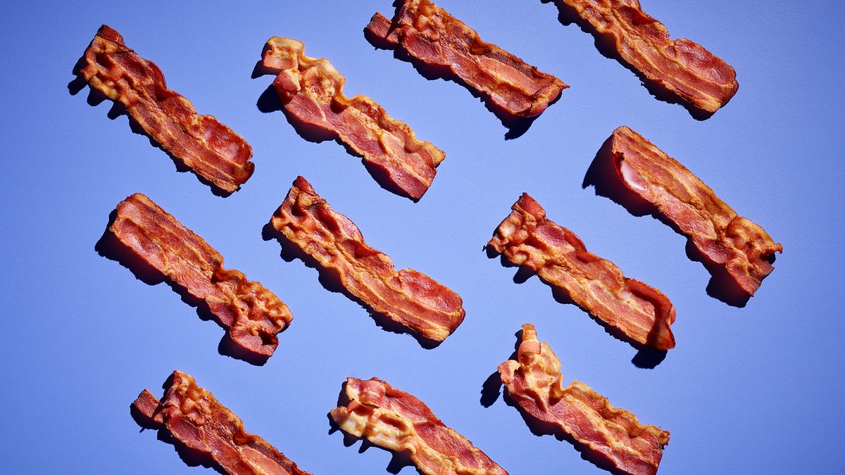 Strips of bacon against a blue background