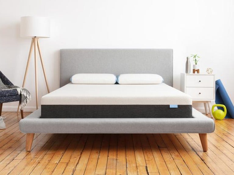 Bear Original best value memory foam mattress in a bright room on a gray bed frame.