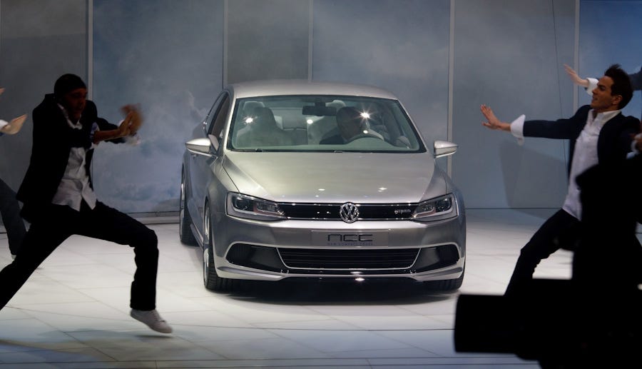 A dance troupe coyly shuffled screens around to gradually reveal VW's New Compact Coupe seen at the Detroit auto show.