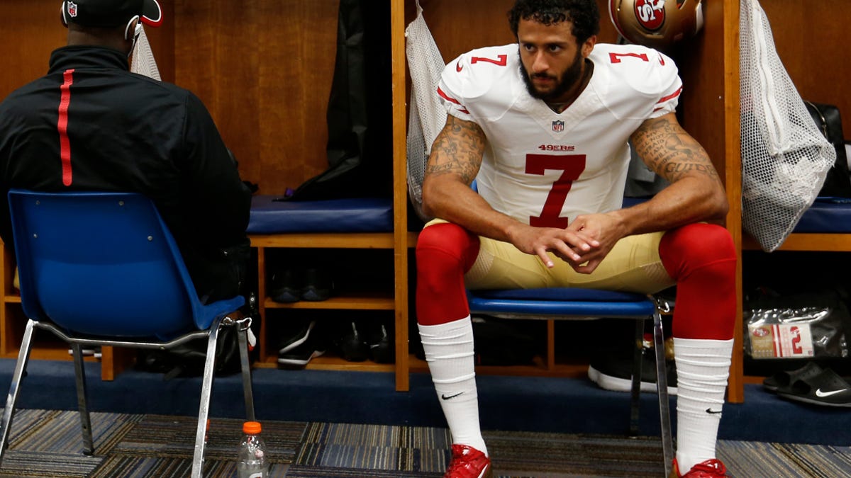Kaepernick in the locker room. he's recently refused to stand during the playing of the national anthem, saying, "I am not going to stand up to show pride in a flag for a country that oppresses black people and people of color."