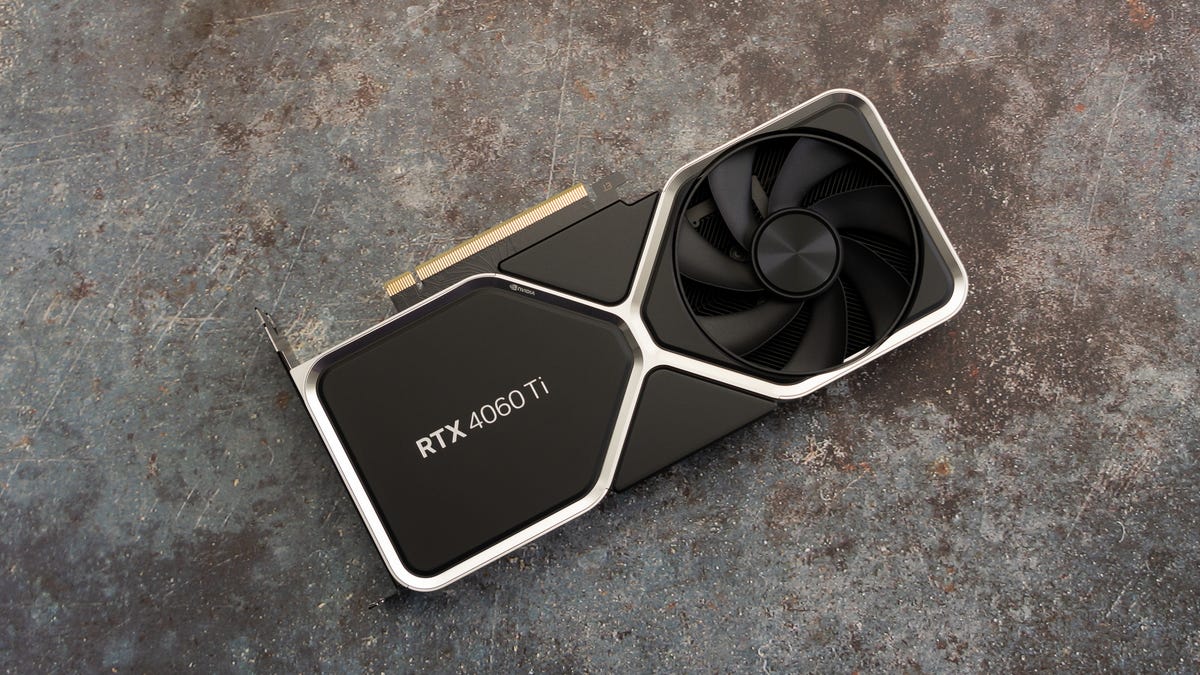 The RTX 4060 Ti FE from above, logo side facing you, angled up to your right, on a mottled gray and rust surface