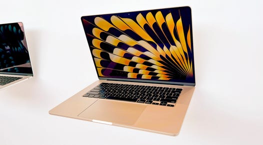 4 apple macbooks with screens open