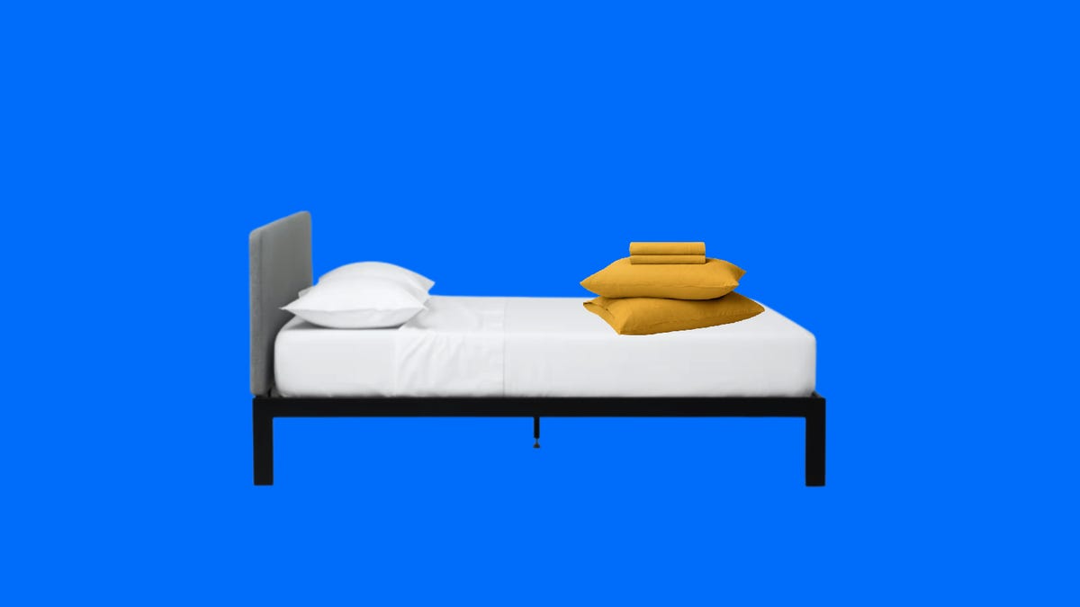Tuft and Needle Bed with yellow sheets and pillows.png