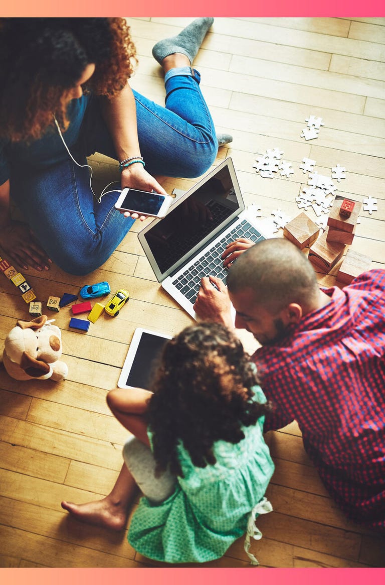 family on floor with electronic devices