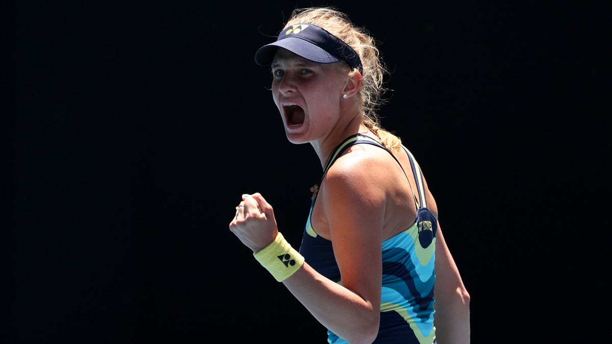 Tennis player Dayana Yastremska, shouting celebration, with a clenched left fist.