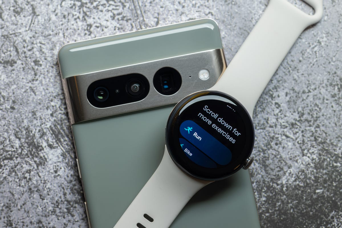 Google's Pixel Watch resting on top of the Pixel 7 Pro