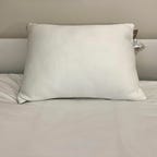 Sleep Number True Temp Pillow on a white bed