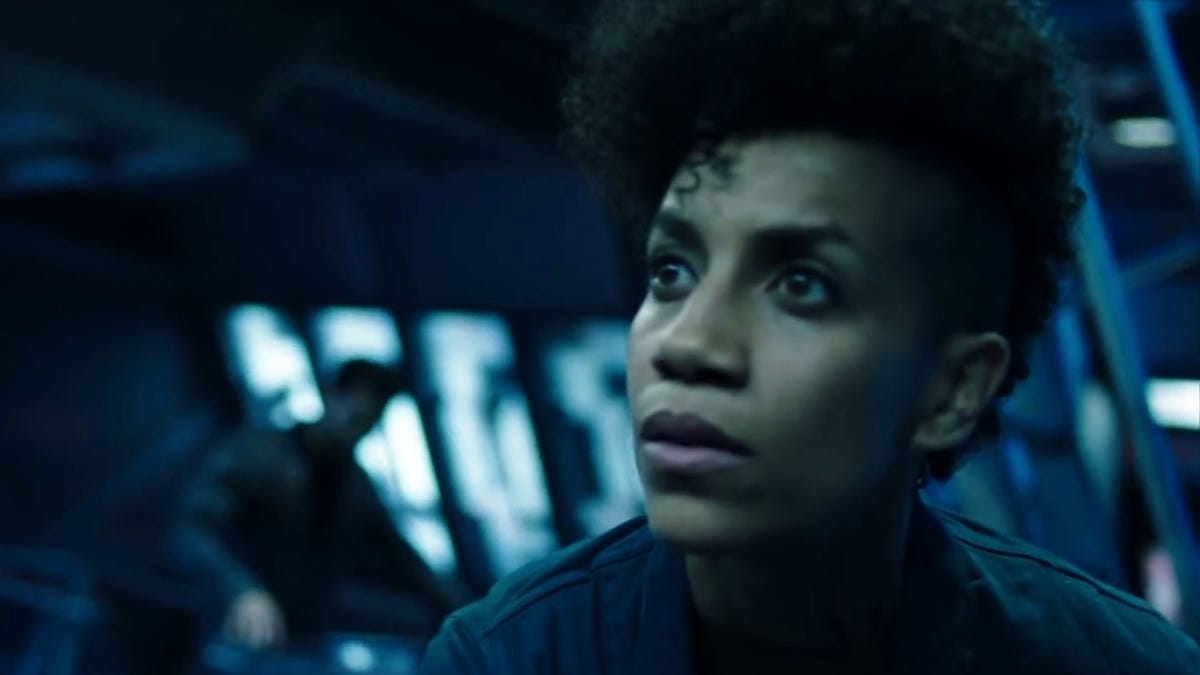 A character in The Expanse stares at something out of view of the camera
