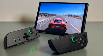 Lenovo gaming handheld with controllers detached, with screen showing driving game