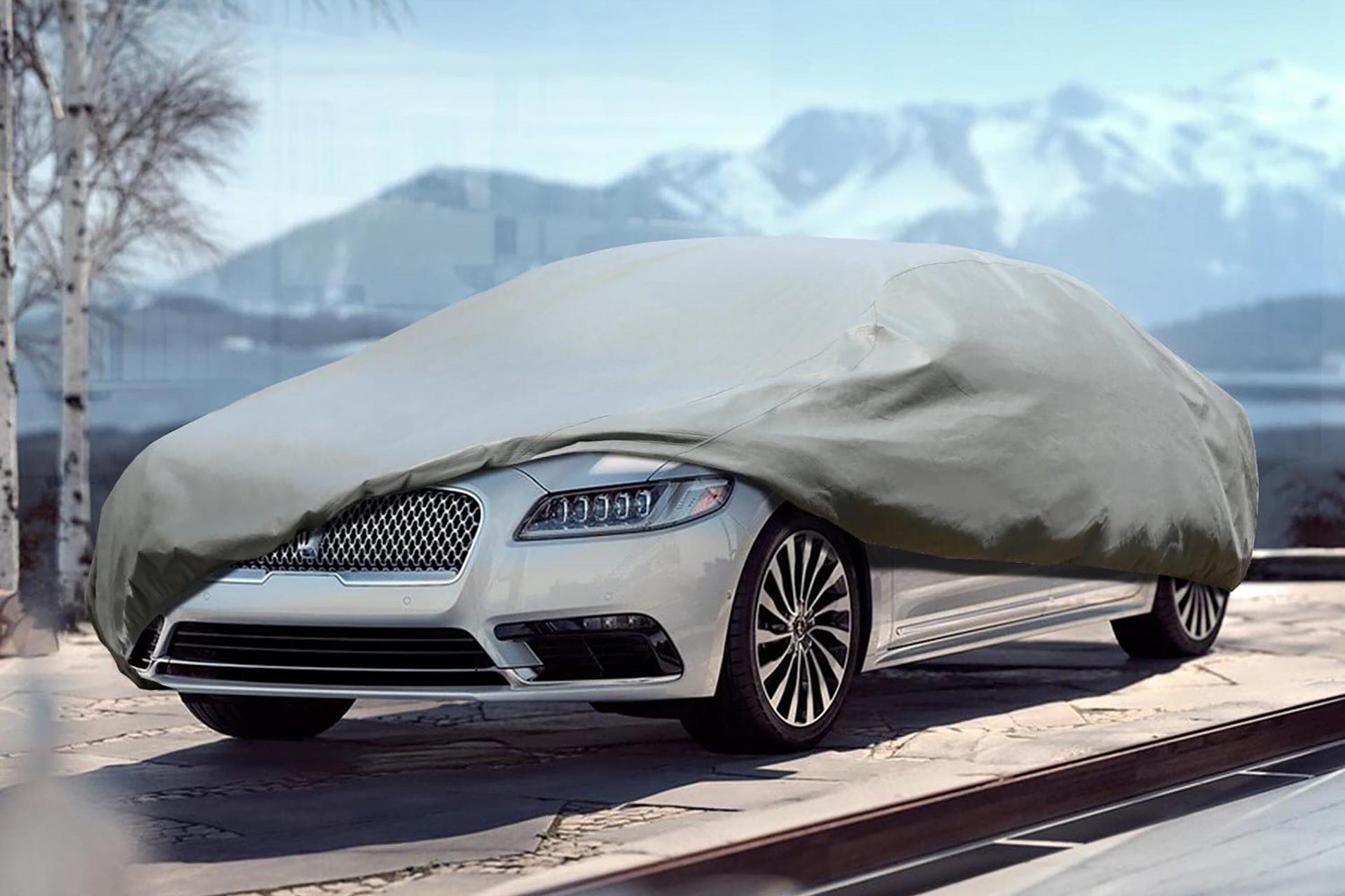 A car partially covered by a car cover