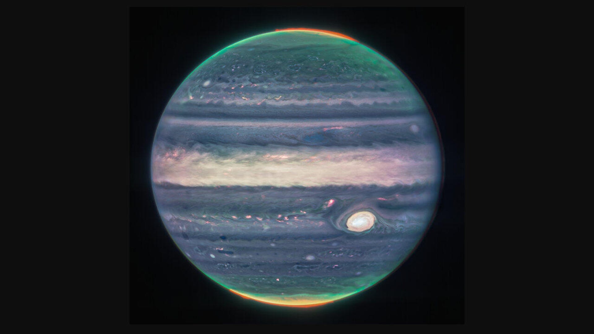 Jupiter appears in swirling shades of blue and purples and white with the Great Red Spot storm looking more like a great white spot.