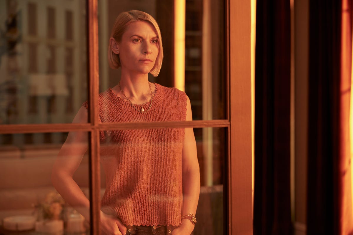 Claire Danes as Rachel Fleishman stands before a window looking contemplative.