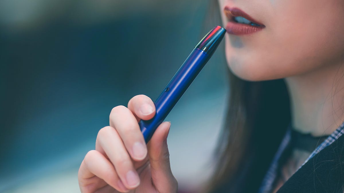 woman-holding-blue-vape-pen