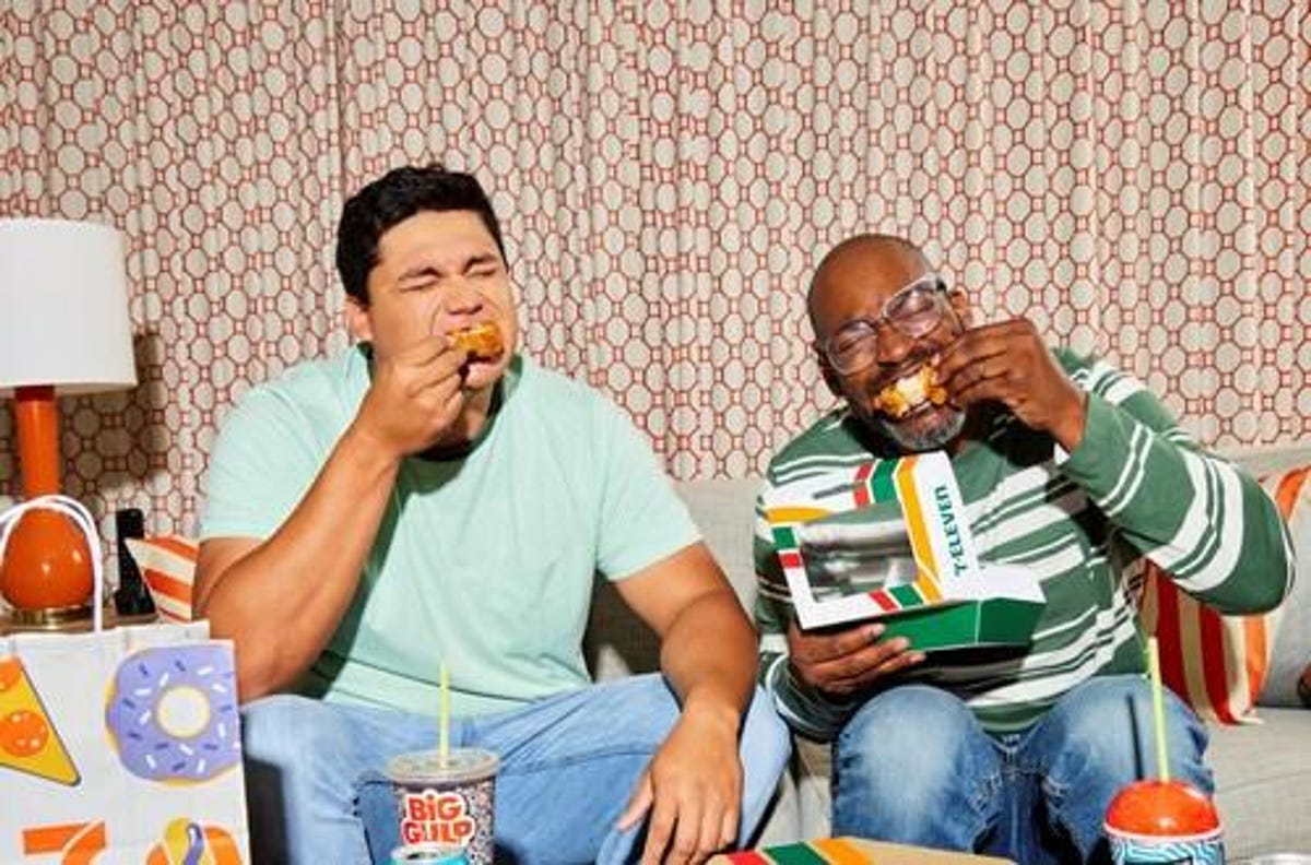 Two men eating 7-Eleven chicken wings