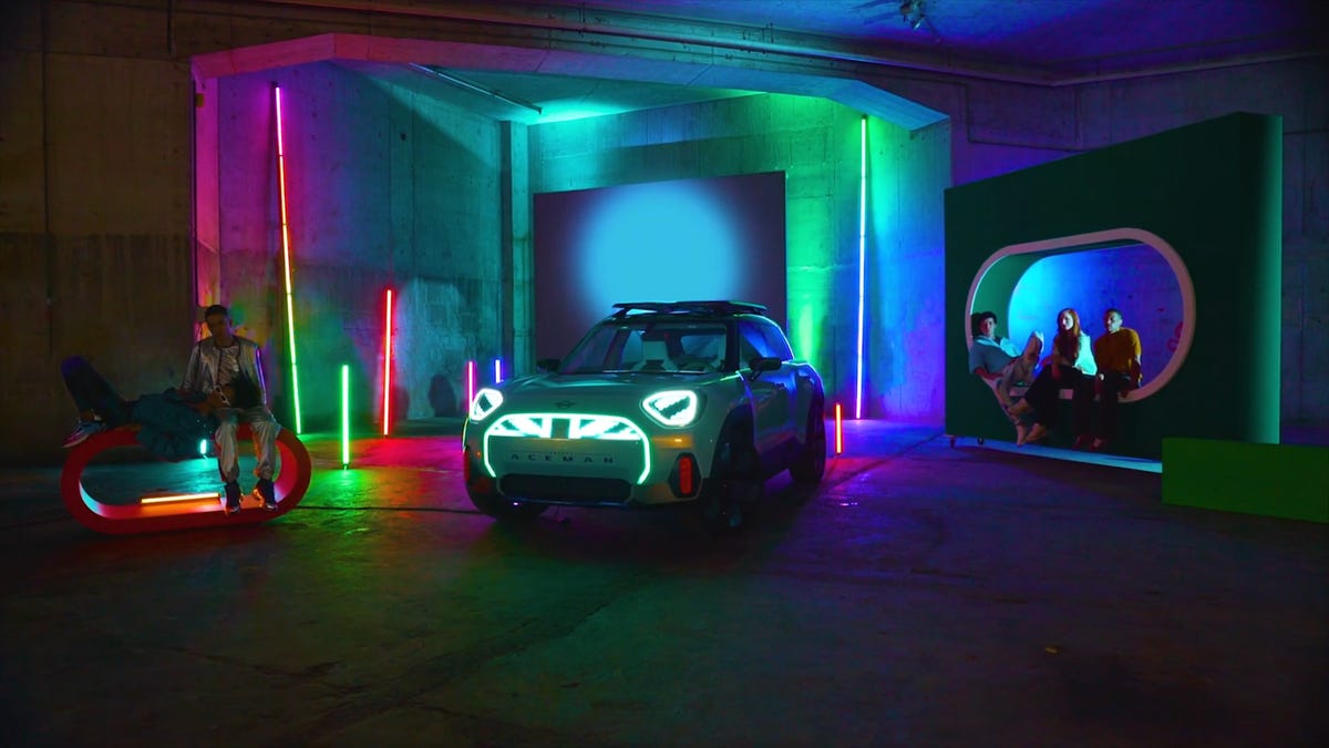 Mini Aceman Concept car in a darkened room projects colored lights