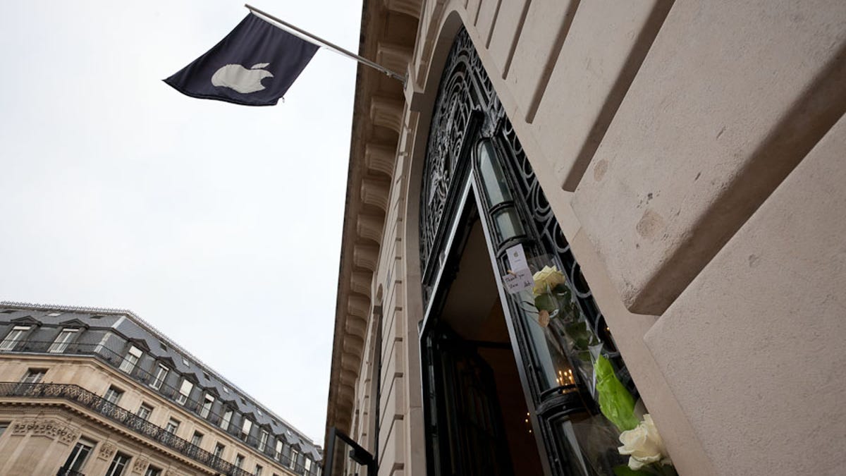 A day after Steve Jobs' death, the Apple store near Paris' opera house had two bouquets of roses, one with a card saying "Thank you, Steve."