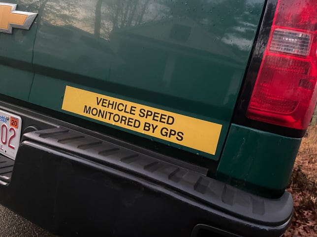 Bumper sticker on a truck reading "Vehicle speed monitored by GPS"