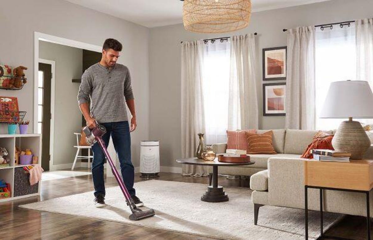 man vacuuming living room