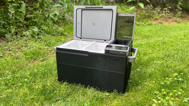 The EcoFlow Glacier electric cooler sits in some grass with its lid open.