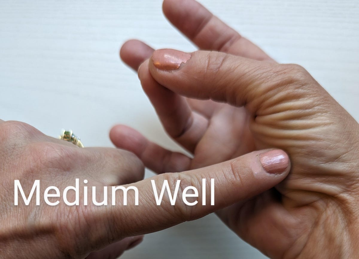 medium well: finger poking hand with thumb and ring finger touching