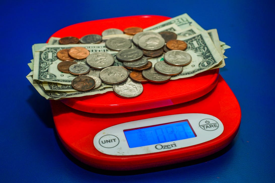 010-stimulus-piggy-bank-tear-falling-money-clip-weighing-cash-scale