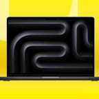 Black MacBook Pro against yellow background