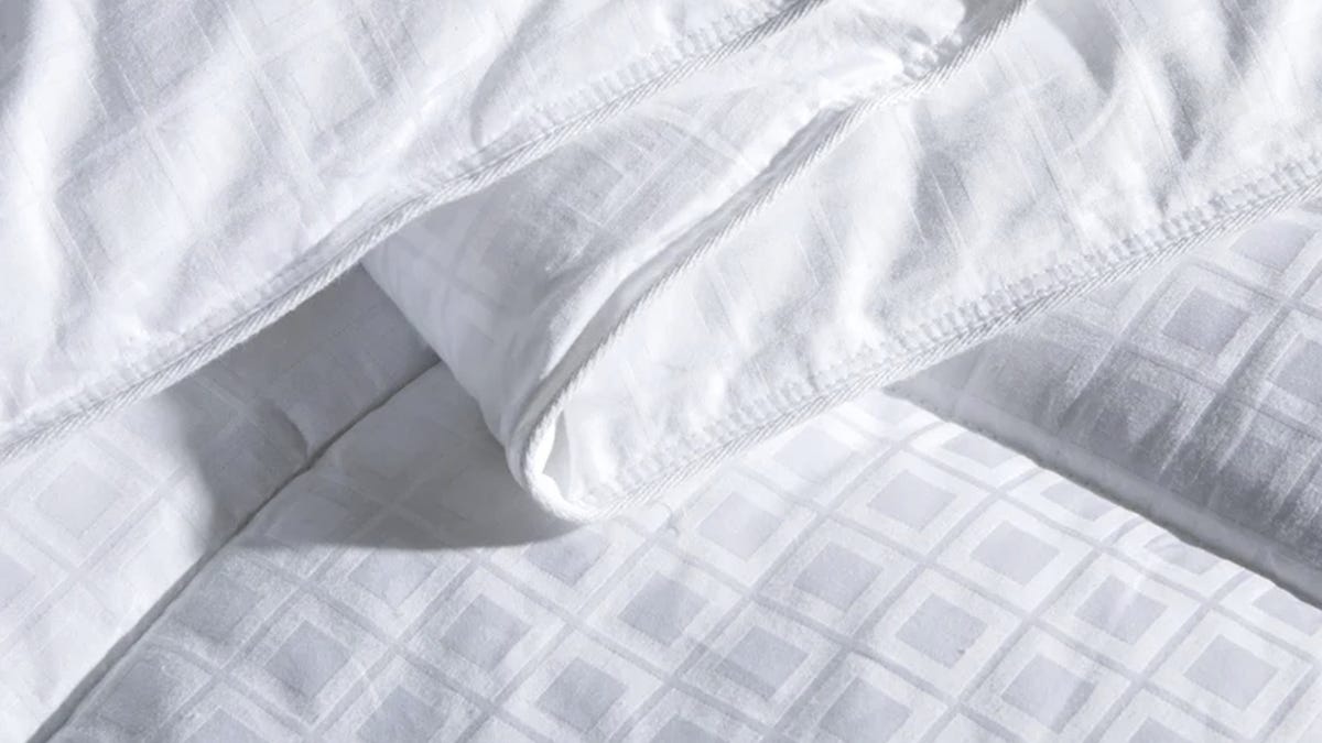 Thick, white comforter with geometric square patters.