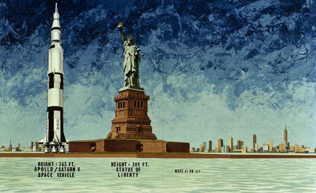 Illustration showing towering Saturn V rocket next to the Statue of Liberty with New York skyline in the background.