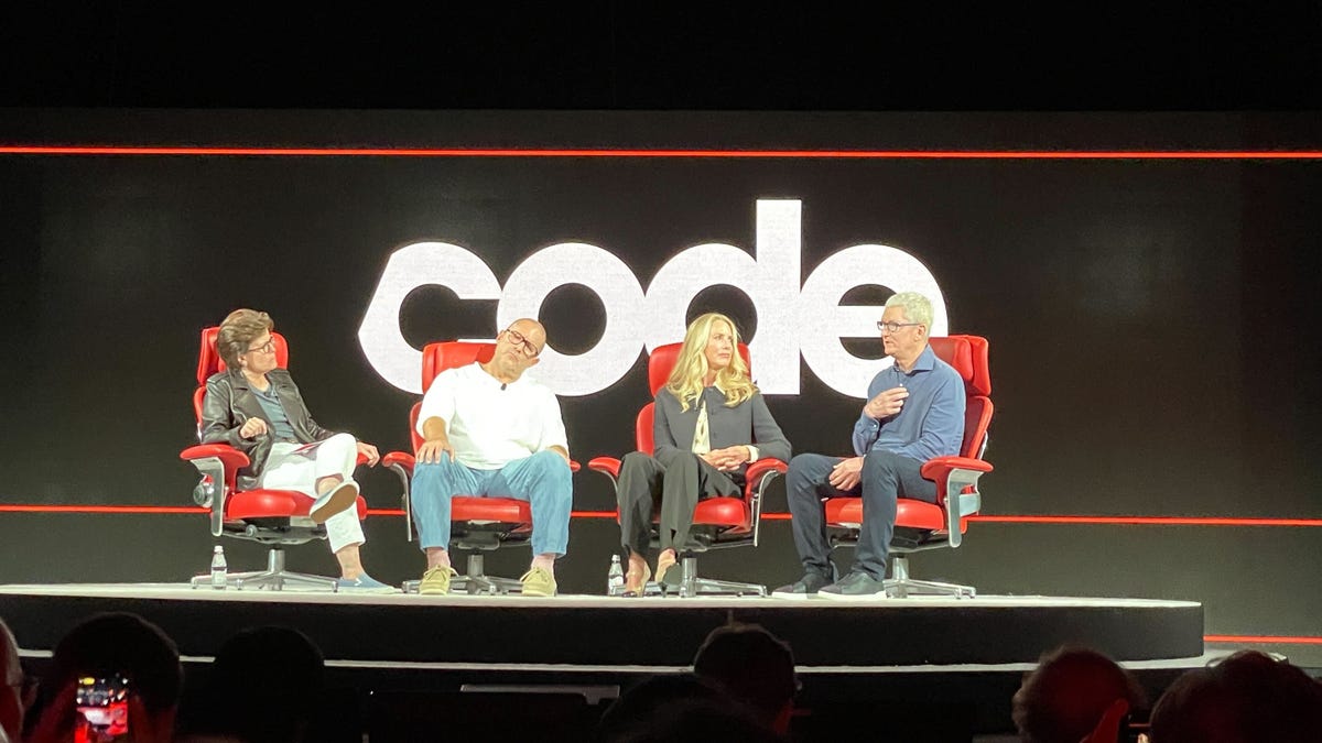 Four people sit in the Code Conference's iconic red chairs to discuss Steve Jobs
