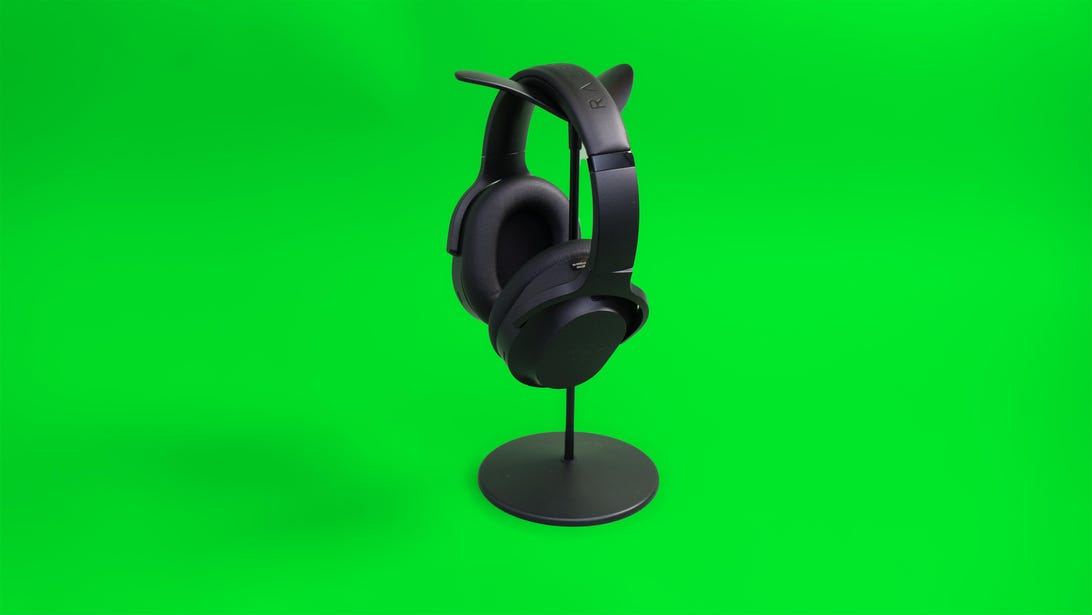 Razer Barracuda Pro gaming headset angled on headset hanger to show both the inside of the right earcup and the outside of the left.