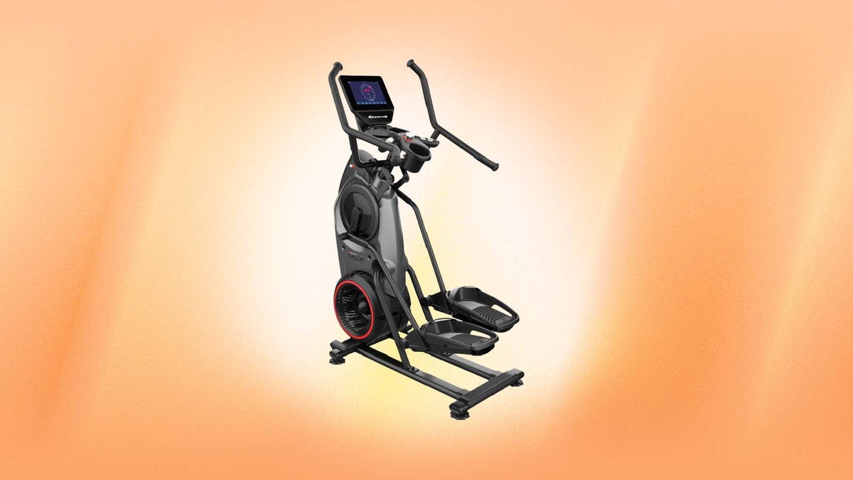 A Bowflex elliptical machine against an orange background.
