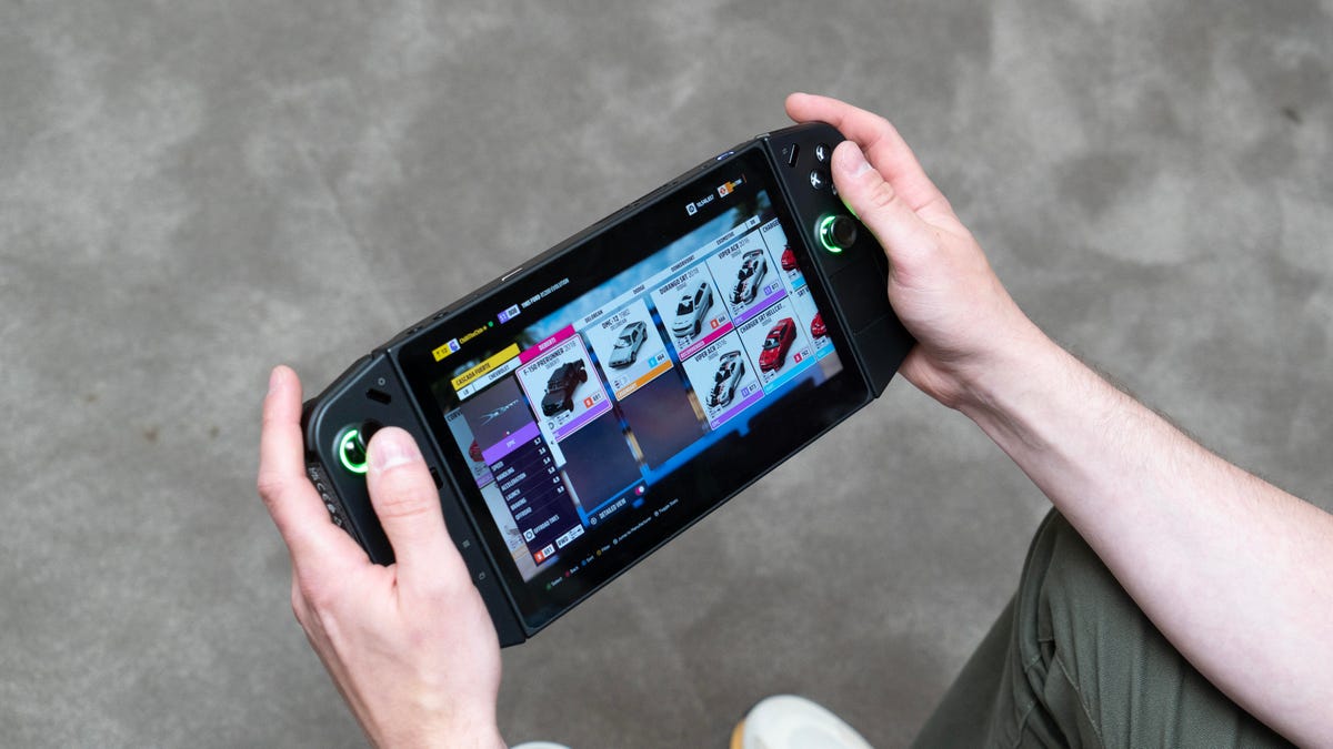 Hands holding a large Lenovo gaming handheld