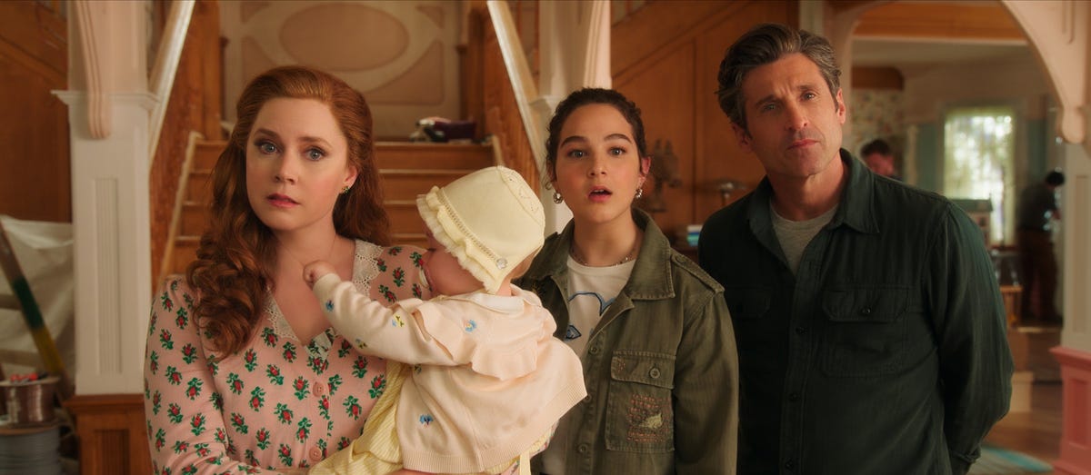 Amy Adams as Giselle holds a baby in Disenchanted with Gabriella Baldacchino as Morgan and Patrick Dempsey as Robert
