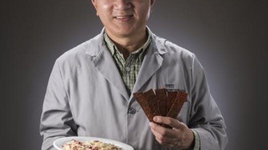 cnet-military-meat-dr-tom-yang-holds-jerky.jpg