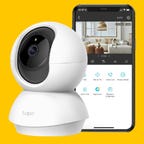The Tapo C210 indoor camera and smartphone with app against an orange background.