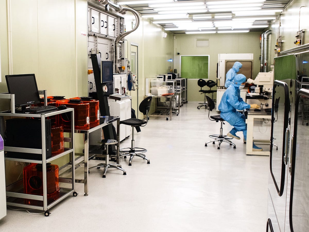 ​InVisage, based in Silicon Valley, adds a think layer of tiny particles called quantum dots to a circular wafer that will be sliced up into hundreds of rectangular image sensors. Here, staff work in an ultra-clean room to avoid contaminating the process. The quantum dots are sensitive to light -- more so than the silicon layer used in today's conventional digital camera technology.