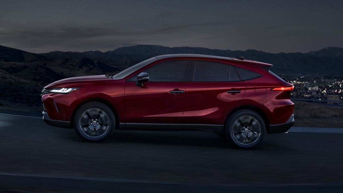 2023 Toyota Venza in red, driving up a mountain pass at night