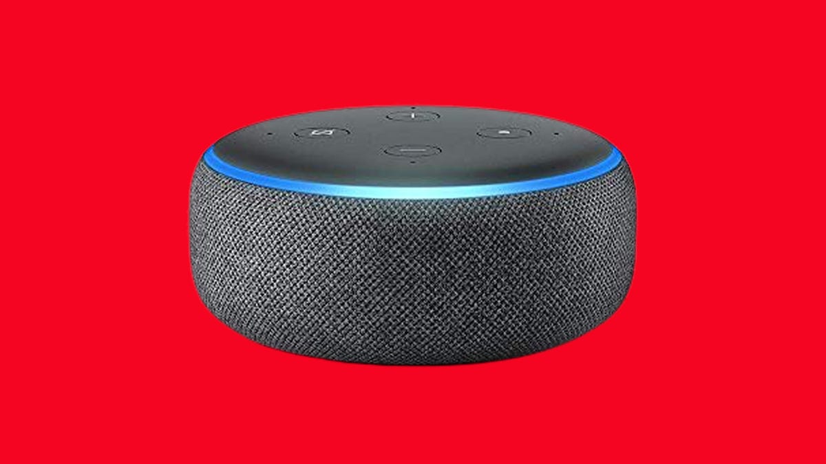The Echo Dot smart speaker against a solid red background.
