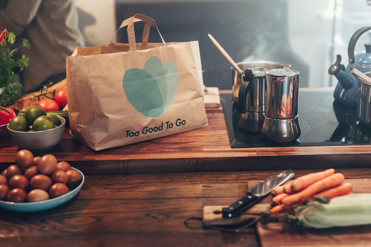 A paper bag on a counter top with ingredients for a meal