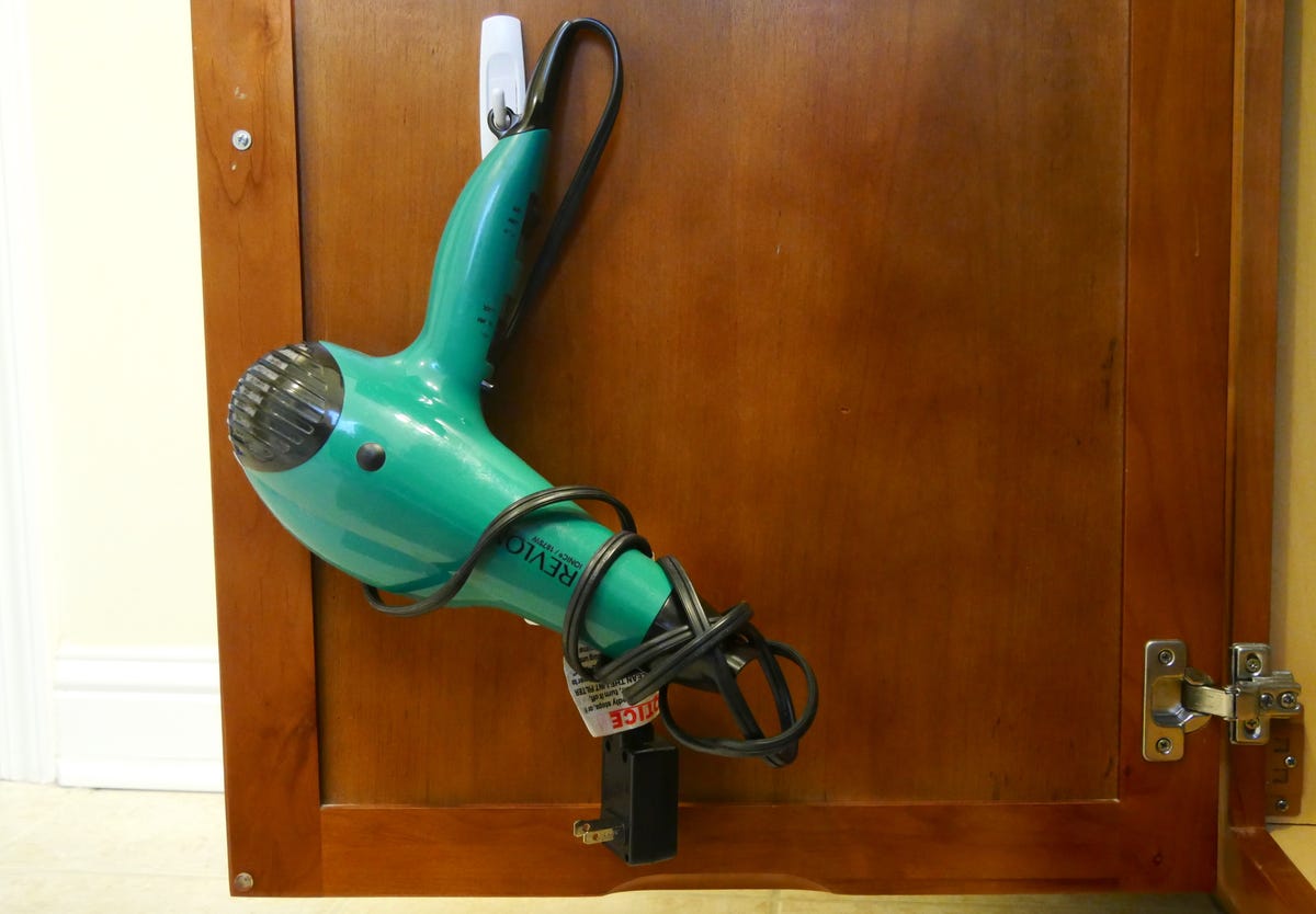 hair dryer hanging from a command hook