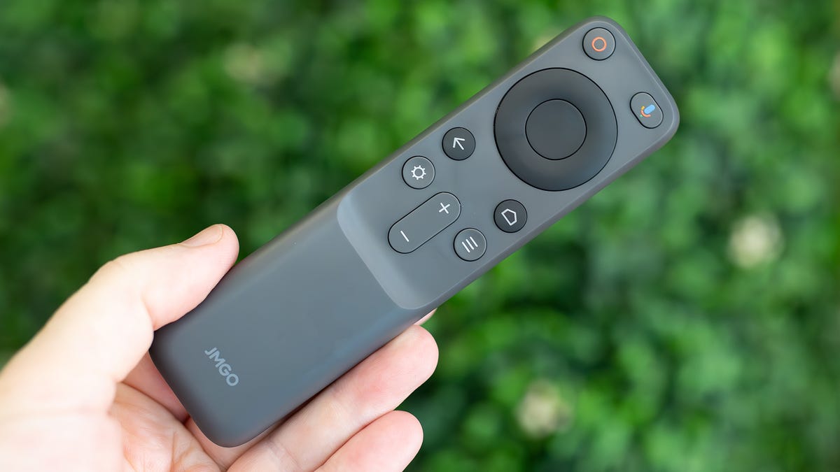 The thin JMGO N1 Ultra remote on a green background.